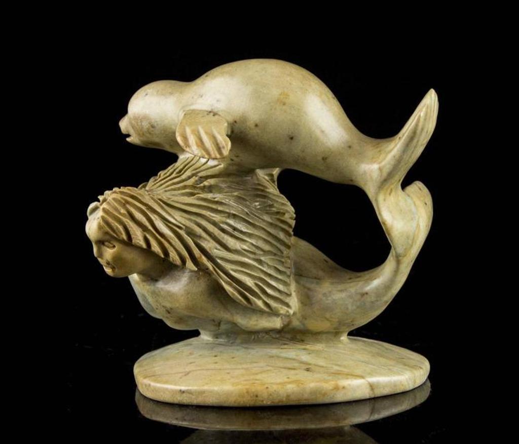 Eric [Amiraq] Lester (1966) - a green stone carving of a Sedna and seal