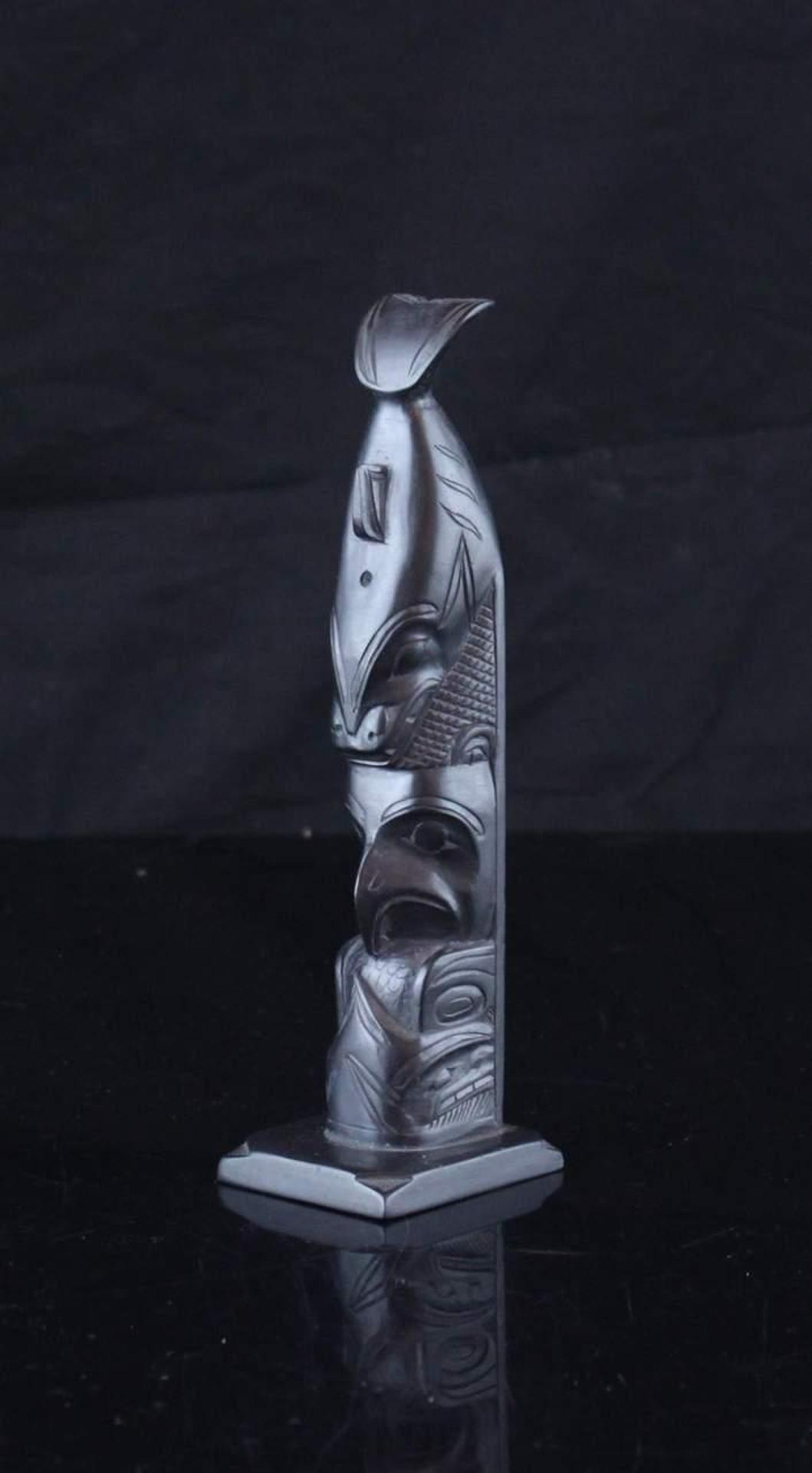 Rufus Moody (1923-1998) - a carved argillite totem pole depicting Killer Whale and Eagle holding Salmon