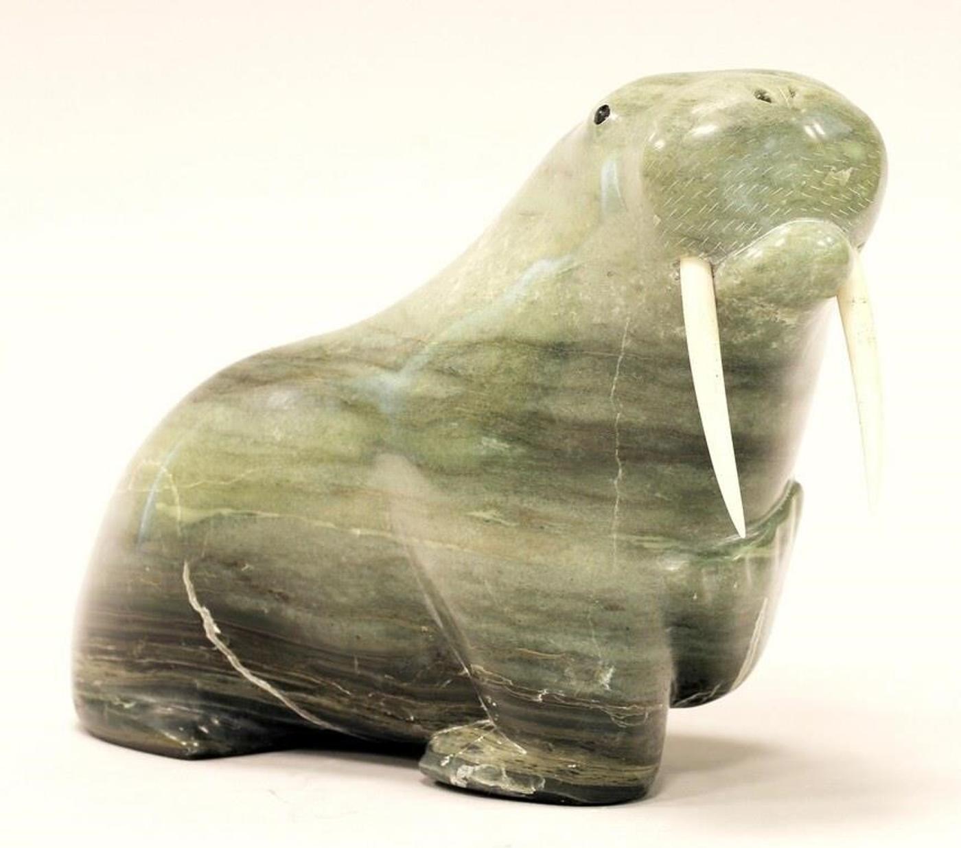 Isaac Meeko (1950) - A marbled green stone carving of a Walrus with bone tusks