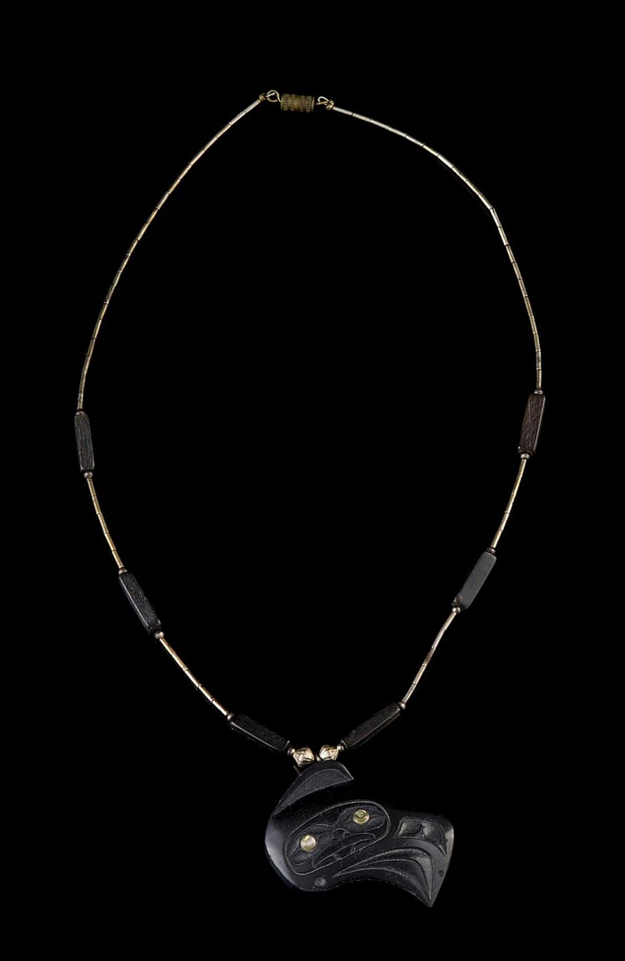 Donald Edgars - a carved argillite pendant titled Raven Man