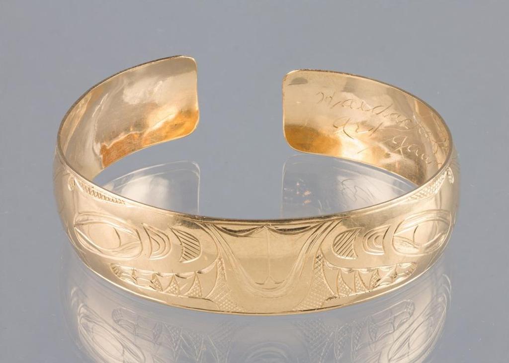 Art Adams - an 18kt yellow gold cuff bracelet decorated with images of Killer Whales