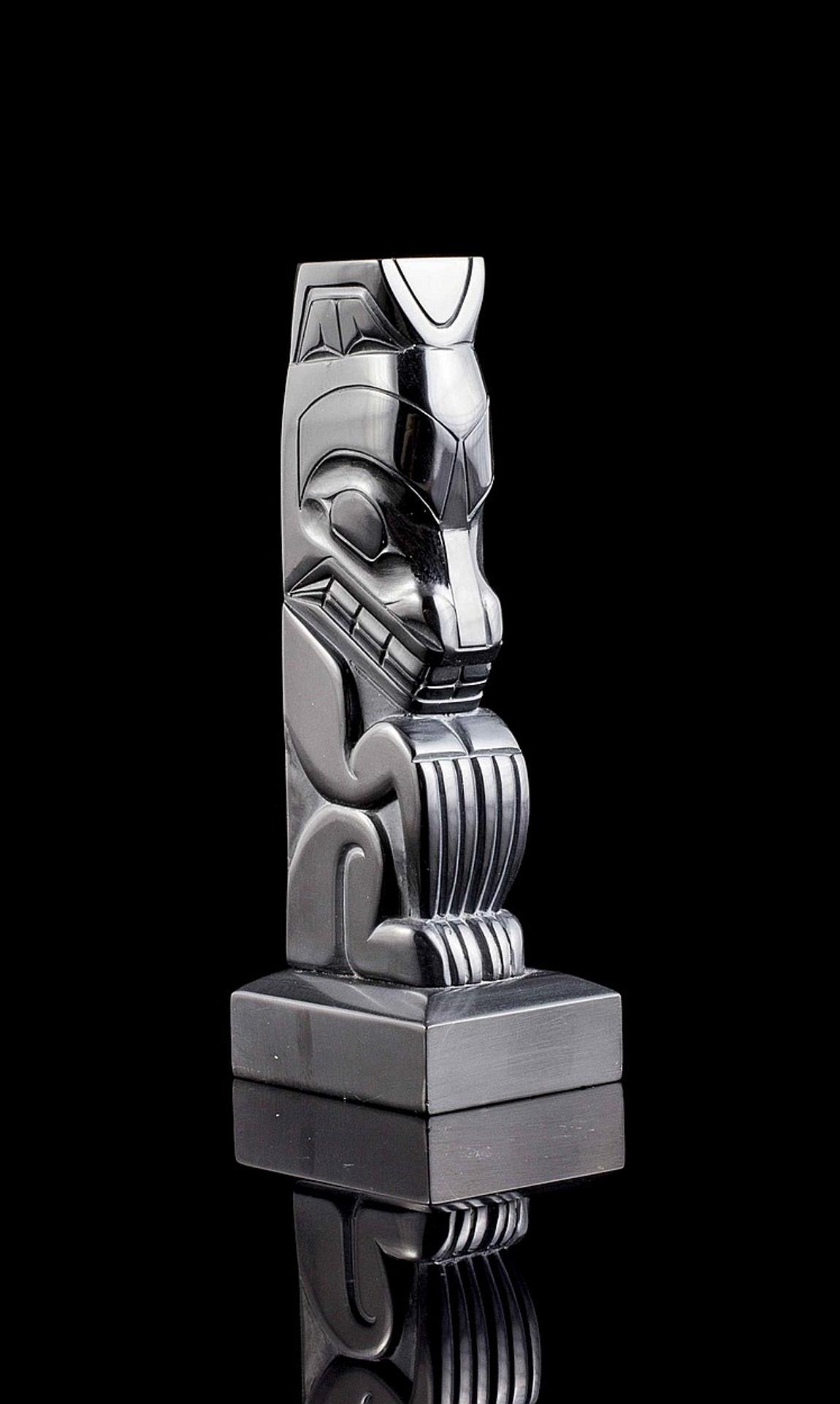 Denny Dixon (1944) - a carved argillite pole depicting a Bear
