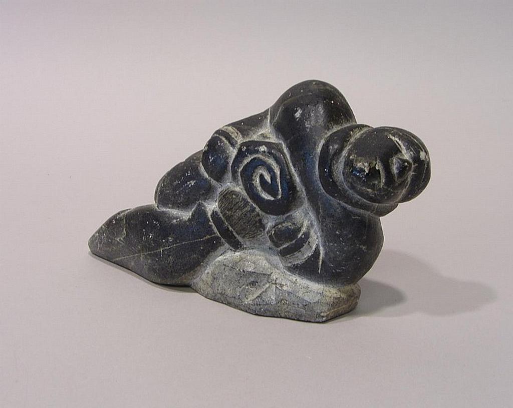 Johnny Jnr. - Inukjuak a grey soapstone carving of a hunter pulling a seal