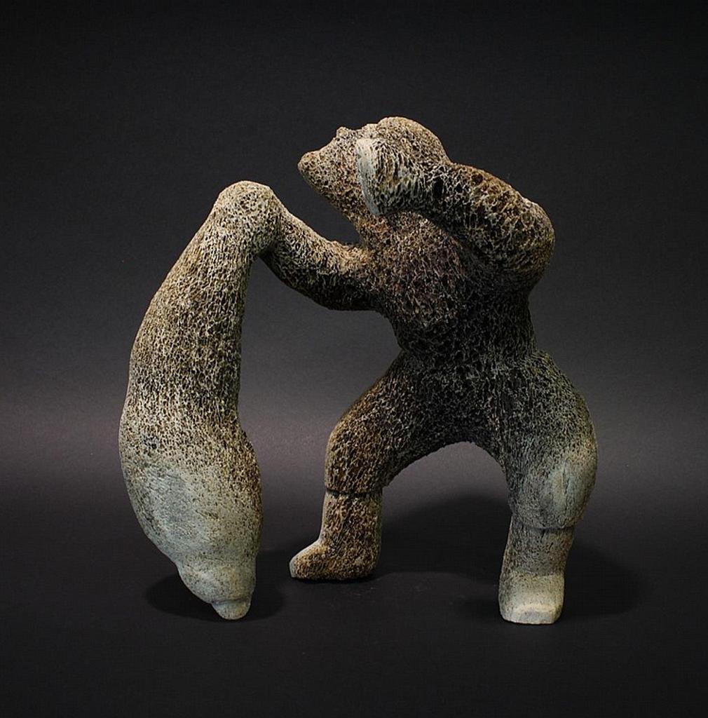 Jake Awam - a whalebone carving of an Inuk holding a seal