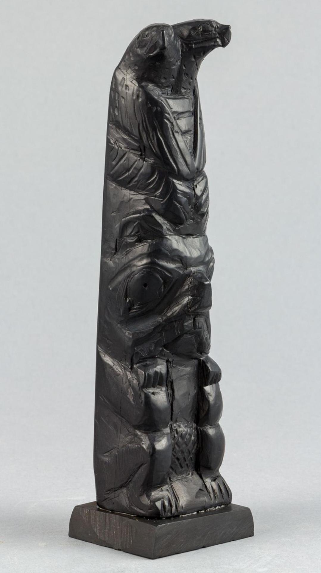 Captain Andrew Brown (1879-1962) - a carved argillite pole depicting turn headed Eagle over Beaver