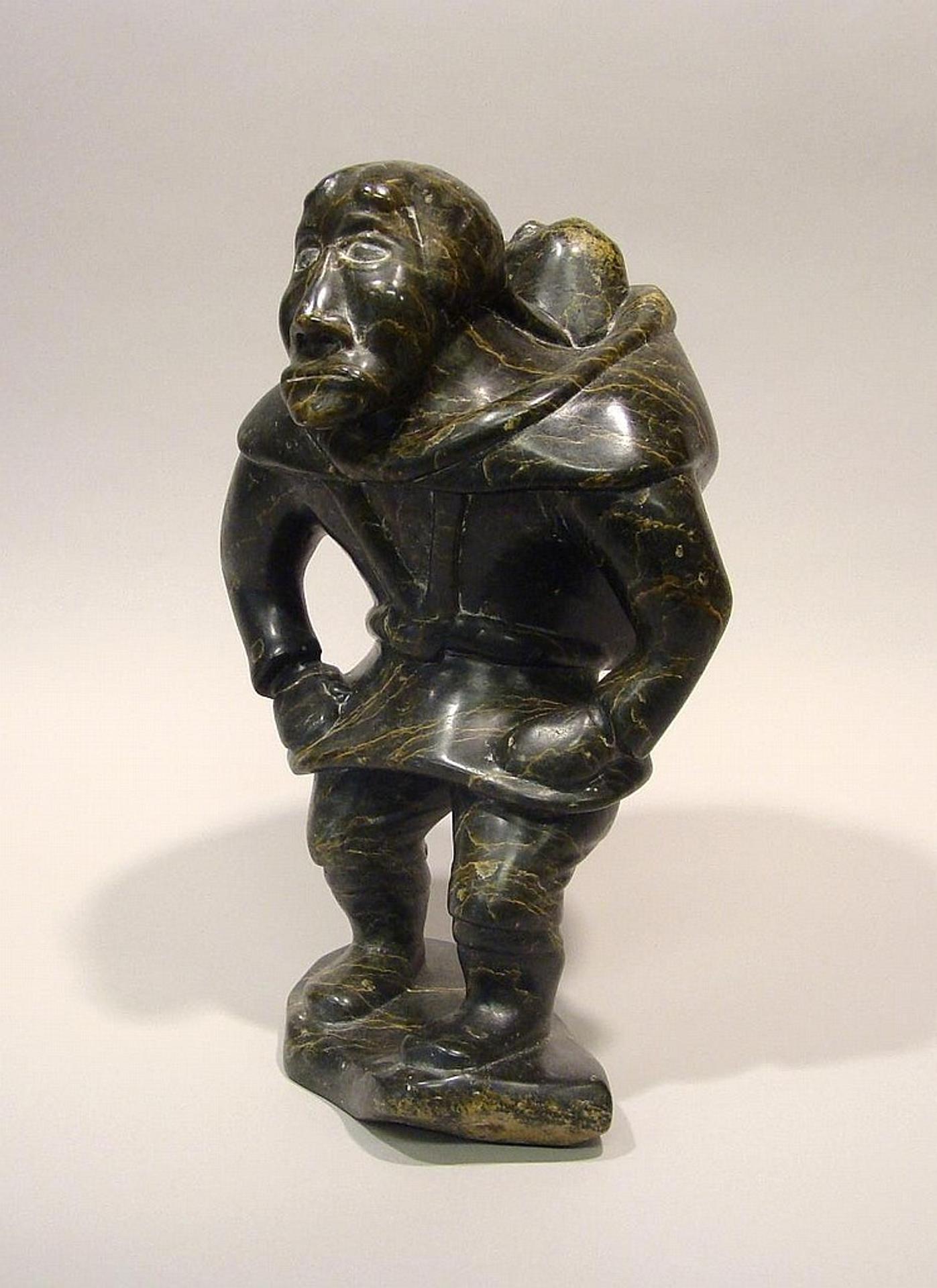 Adamie Alariaq (1930-1990) - Cape Dorset a serpentine carving of an Inuk with a child upon her back