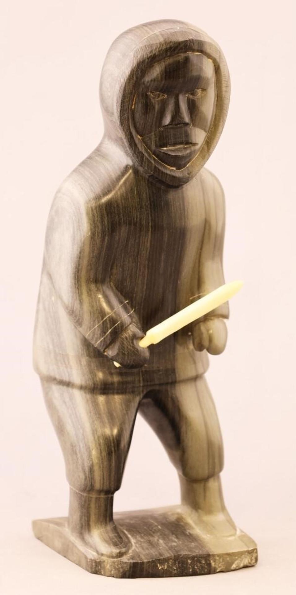 Allie Appaqaq Apawkok (1915-1986) - a grey-black stone carving of a Hunter with bone knife; with igloo card